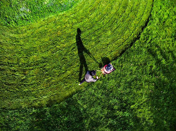 Person mowing their lawn in curves